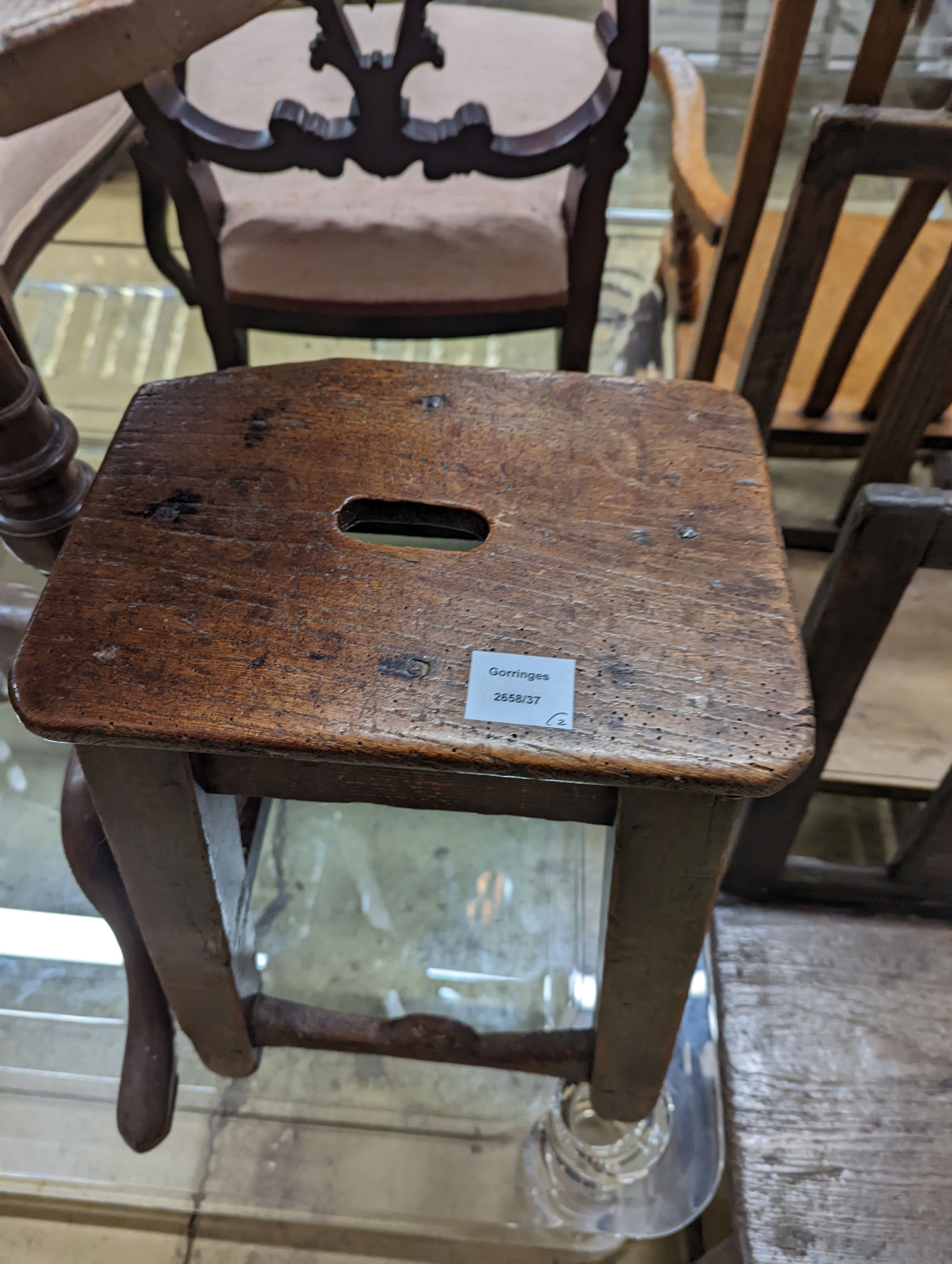 A 19th century oak stool and an oak tripod table, table diameter 53cm, 70cm height